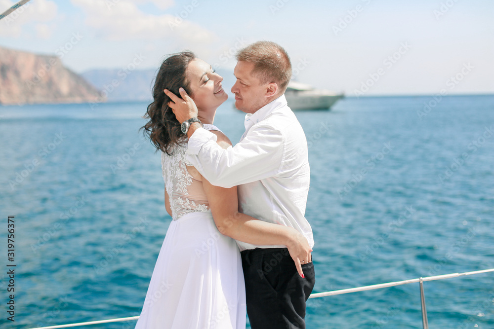 Family on honeymoon while on holiday on a sea sailing yacht in the open sea. Family on honeymoon while on holiday on a sea sailing yacht in the open sea.