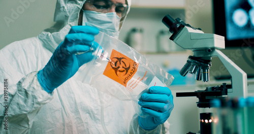 medium shot lab tech with sample of Wuhan Coronavirus virus