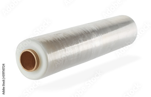 Roll of plastic film on a cardboard coil, isolated on a white background with a shadow. Diagonal sharpness.