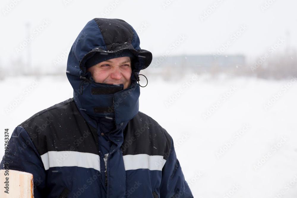 Closeup portrait of a worker on the ice of a frozen river