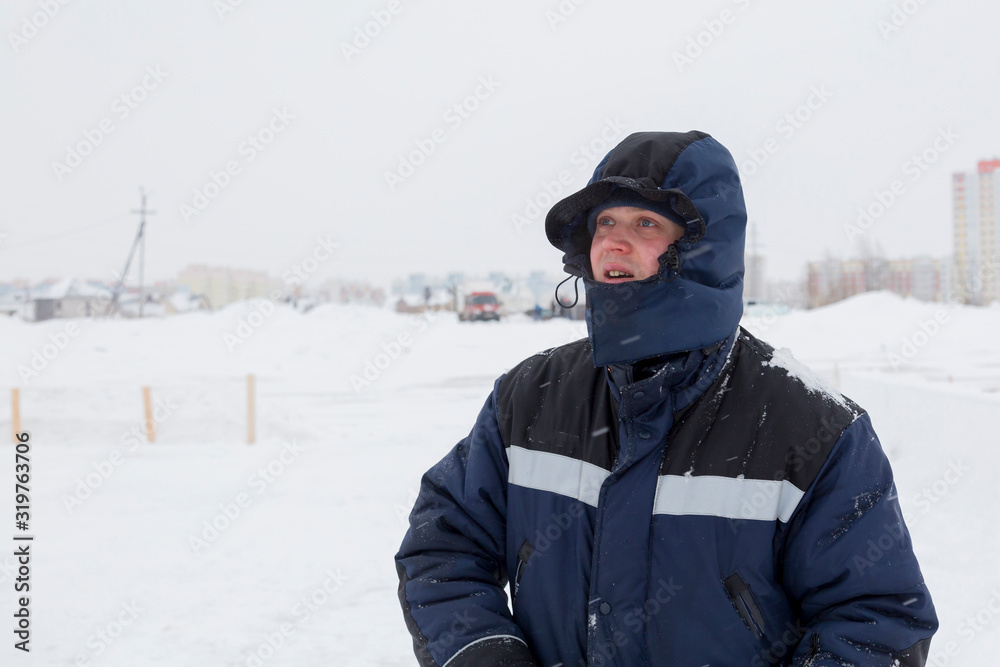 Closeup portrait of a worker on the ice of a frozen river