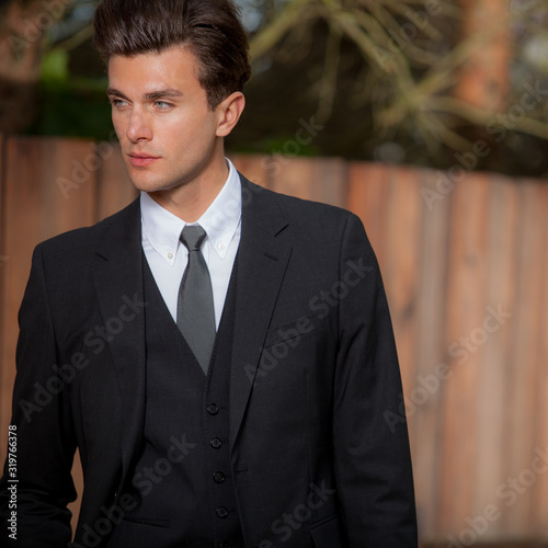 Young elegant handsome man posing outside.