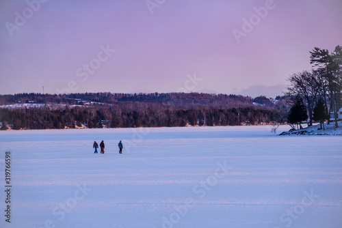 people walking on frozen lake
