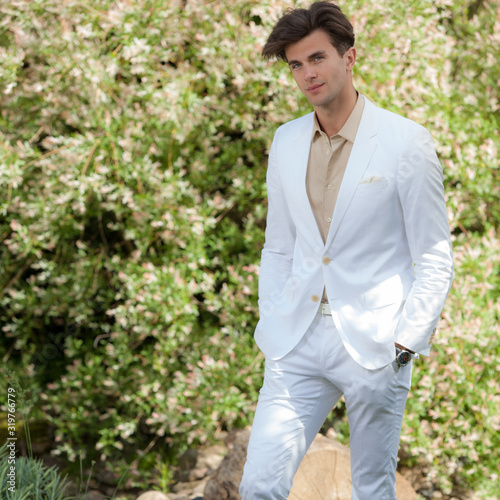 Young elegant handsome man posing outside.