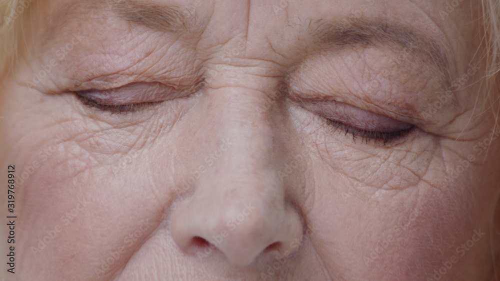 Close-up macro view of beautiful mature woman green eyes opening and looking straight on a wrinkled face. Close-up macro view of beautiful mature woman green eyes opening and looking straight on a wrinkled face.