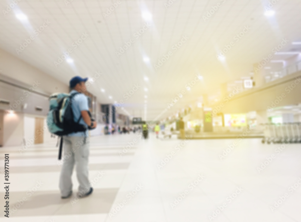 Blur background. Airport scene. People walking out of focus.