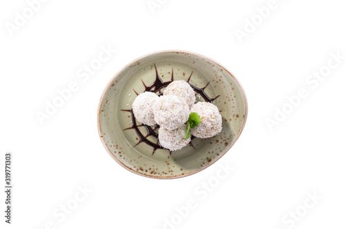 Homemade candies with coconut on grey plate isolated on white background