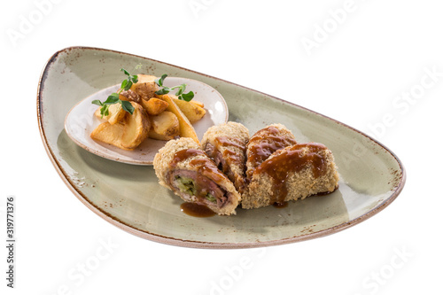 Golden fried stuffed pork with pickles and potato wedges isolated on white background