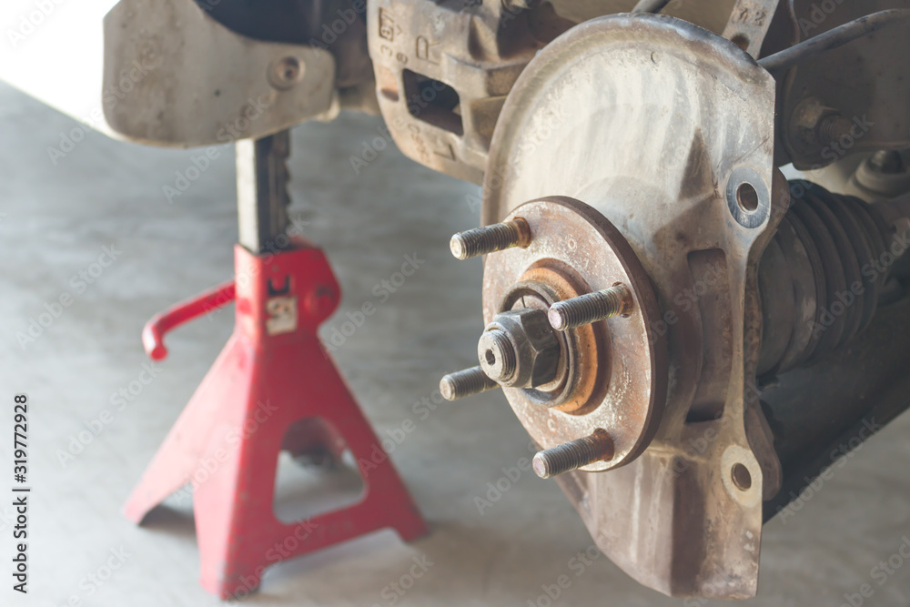 Car disc brake showing dust cover and brake caliper without disc plate, Car service.