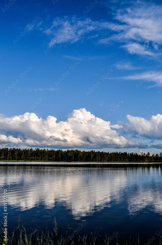 Reflection of clouds in the water of a swedish lake.