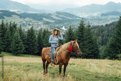 Female tourist on horseback at mountains