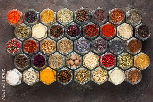 Fototapeta Naklejka Na Ścianę i Meble -  Different kinds of spices and herbs in glass on grey background