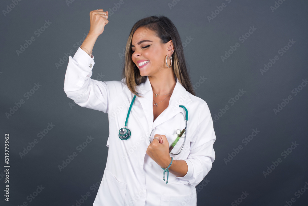 Beautiful doctor woman happy and excited expressing winning gesture. Successful and celebrating victory, triumphant. Beautiful doctor woman happy and excited expressing winning gesture. Successful and celebrating victory, triumphant.