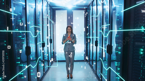 IT Administrator Woman Activating Modern Data Center with Digital Data Flow Moving Through Server Racks. Digitalization of Information. Looped 3D Animation of Graphic Circuit Lines, Numbers and © Fractal Pictures