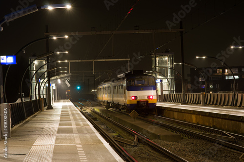 Train is waiting on platform at night