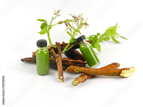 Ayurvedic herbs, Azadirachta indica or neem leaves and neem leaf juice. And branches on a white background.