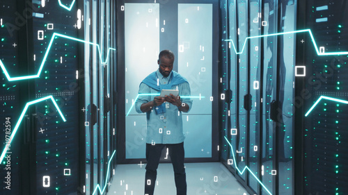 Digitalization of Information. Black Young Server Administrator with Digital Tablet Working in High Tech Data Center. 3D Looped Animation of Data Flow with Graphic Elements, Glowing Board Lines, and photo