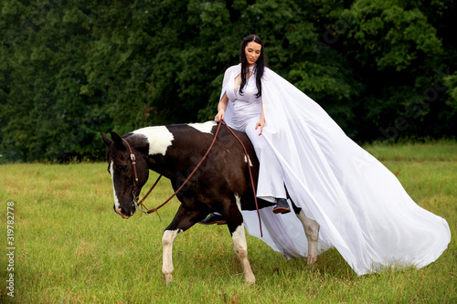 girl riding horse in dress