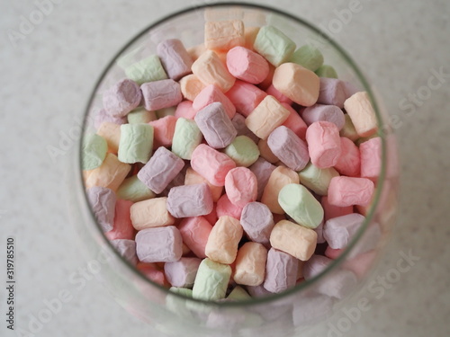 Gentle marshmallow in glass vase isolated on white