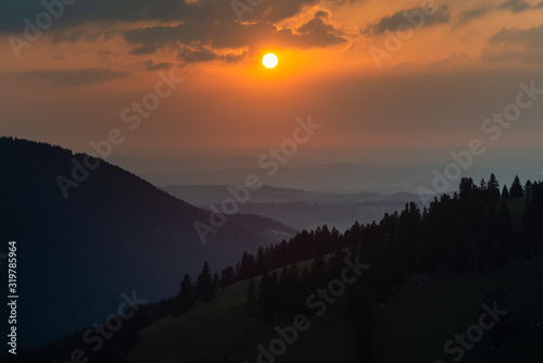 Blick über das Jenbachtal bei Bad Feilnbach auf das bayerische Voralpenland und den Sonnenuntergang, Bayern, Deutschland photo