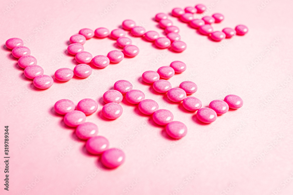 Words made with pink pills, love
