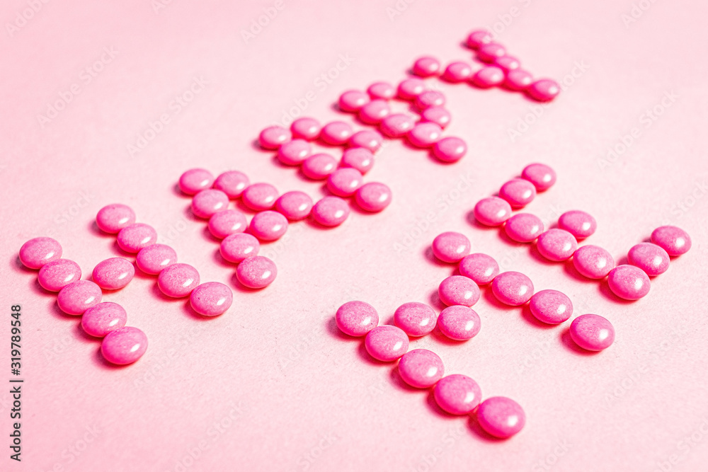 Words made with pink pills, happy