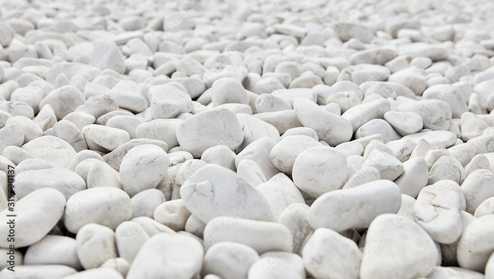 White pebbles stone background. Relaxation, meditation and calmness around us. White pebbles stone background. Relaxation, meditation and calmness around us.