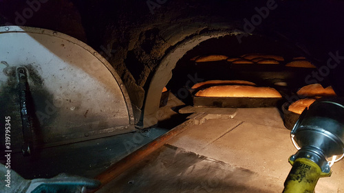 bread oven  traditional , bread that comes out of the oven in Vrosina village greece photo