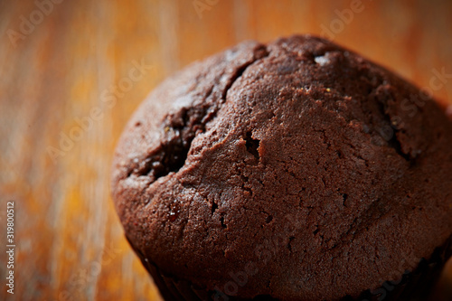 Chocolate cupcake on wooden background 