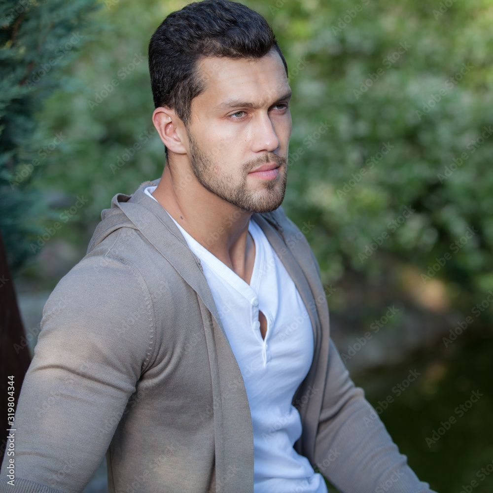 Young elegant handsome man posing outside. Young elegant handsome man posing outside.