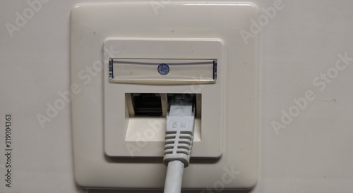 White network socket with a network cable
