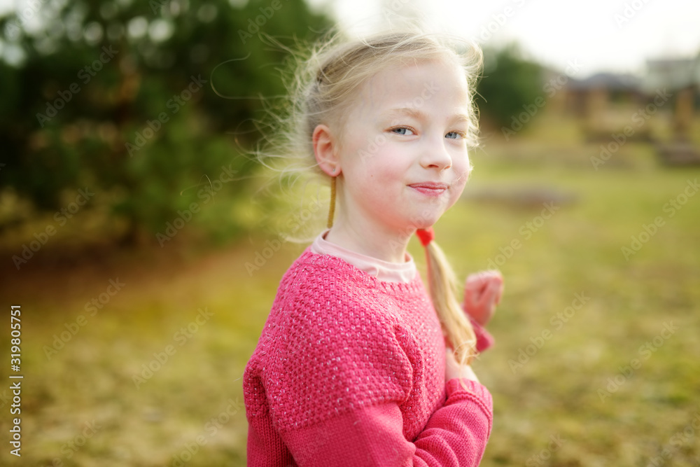 Cute girl having fun on beautiful spring day. Active family leisure with kids. Family fun outdoors. Cute girl having fun on beautiful spring day. Active family leisure with kids. Family fun outdoors.