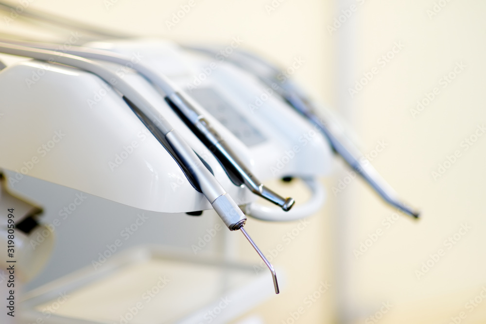 Different dental instruments and tools in a dentists office Different dental instruments and tools in a dentists office