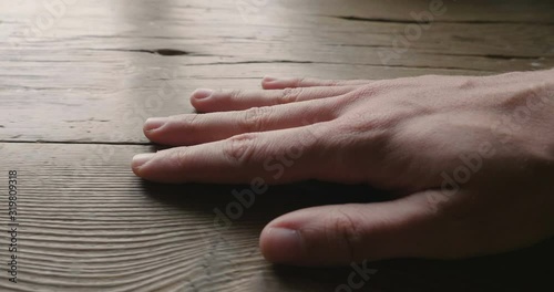 man hand touch oil finished olive wood surface