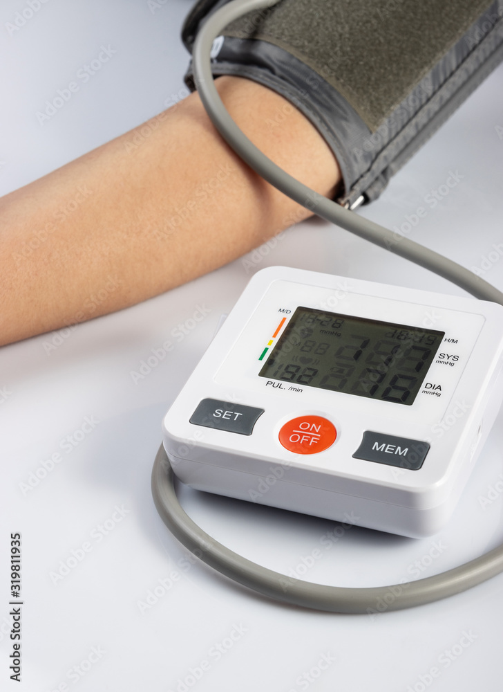 Blood pressure measuring by tonometer on white background. Healthcare and medical concept Blood pressure measuring by tonometer on white background. Healthcare and medical concept