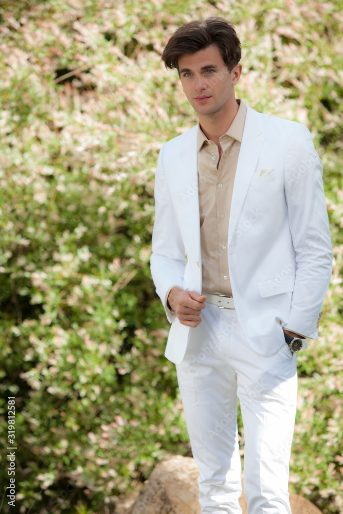 Young elegant handsome man posing outside. Young elegant handsome man posing outside.