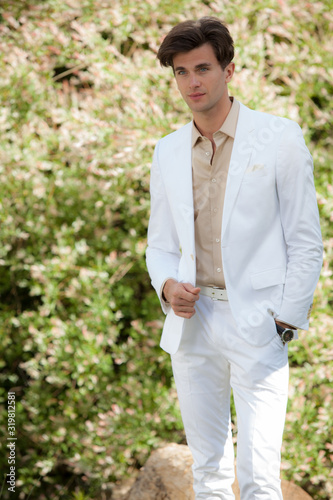 Young elegant handsome man posing outside.