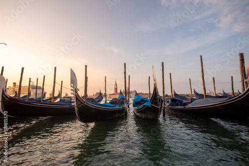 Fototapeta Naklejka Na Ścianę i Meble -  Gondolas of Venice Italy in the morning against the backdrop of sunrise
