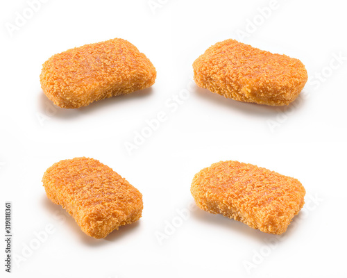 Four diferents sizes and shapes of a crispy and delicious chicken nuggets, isolated on white background. A popular fast food  made from chicken meat that is breaded or battered, then deep-fried or bak photo