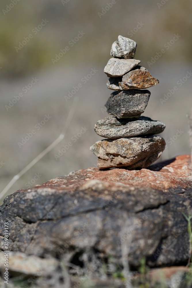 Rocks are piled in a stack known as a ciarn to mark a hikers passage along a trail. Rocks are piled in a stack known as a ciarn to mark a hikers passage along a trail.