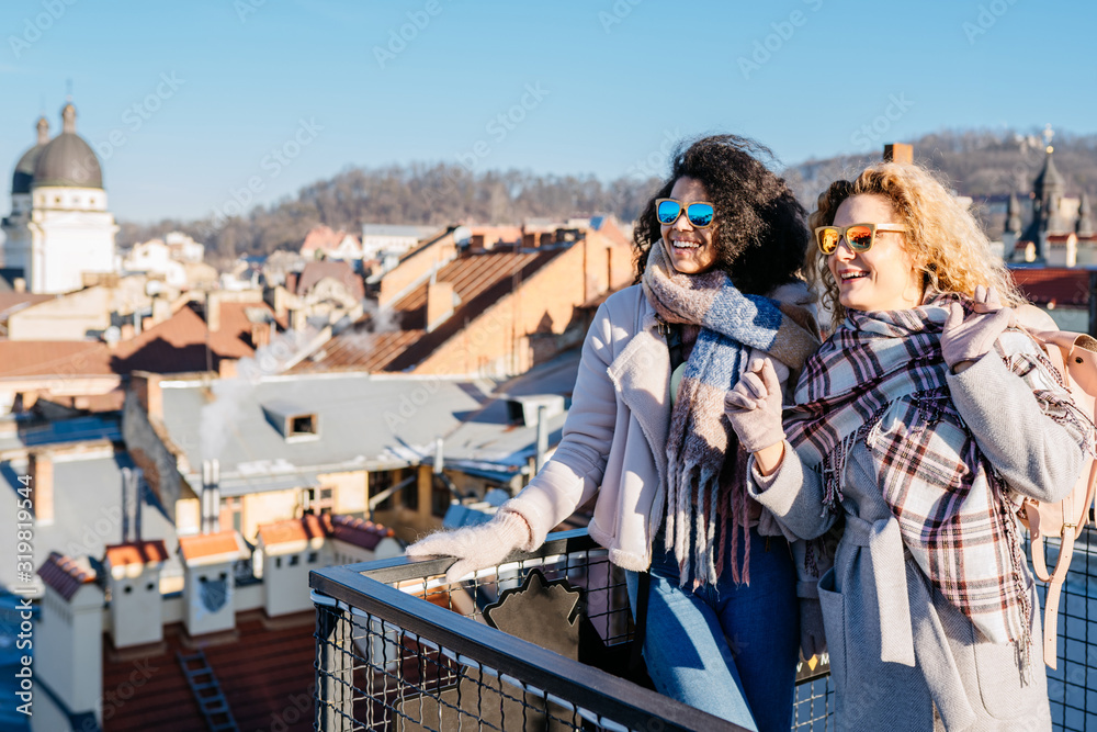 Two female multi ethnic friends enjoying view