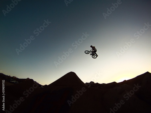 Leinwand Poster Low Angle View Of Bmx Biker Against Blue Sky