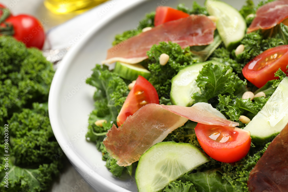 Delicious salad with kale leaves on table, closeup Delicious salad with kale leaves on table, closeup