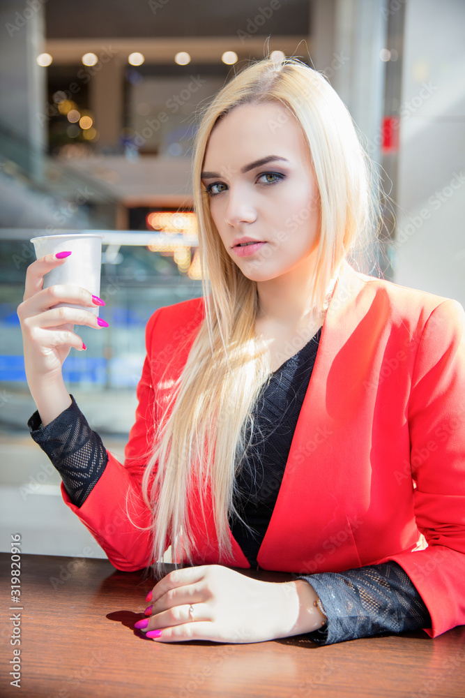 Beautiful young blonde posing in a cafe