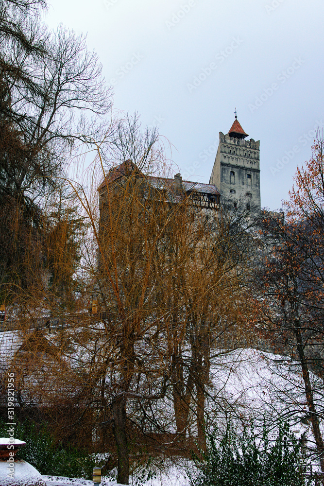 Mystery winter landscape view of Bran Castle on the hill. Also called Dracula's Castle. Famous touristic place and travel destination in Romania
