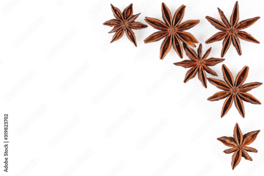 Anise star. Mockup with some star anise fruits and copy space. Close-up on white background with shadows, flat lay view of chinese badiane spice or Illicium verum. Anise star. Mockup with some star anise fruits and copy space. Close-up on white background with shadows, flat lay view of chinese badiane spice or Illicium verum.