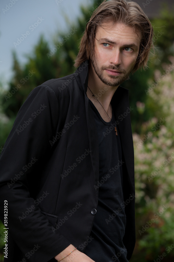 Young elegant handsome man posing outside. Young elegant handsome man posing outside.