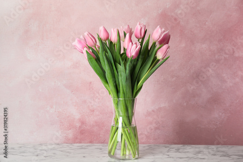 Beautiful pink spring tulips on marble table