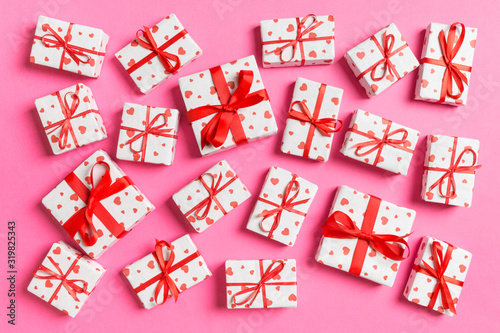 Top view of white gift boxes with hearts on colorful background. Valentine's Day concept