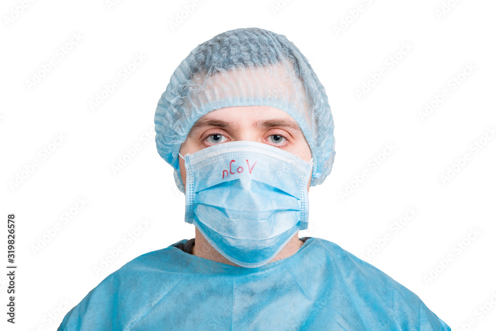 Portrait of young man wearing medical uniform and protective mask with nCoV word isolated on white background. Coronavirus and health care concept Portrait of young man wearing medical uniform and protective mask with nCoV word isolated on white background. Coronavirus and health care concept